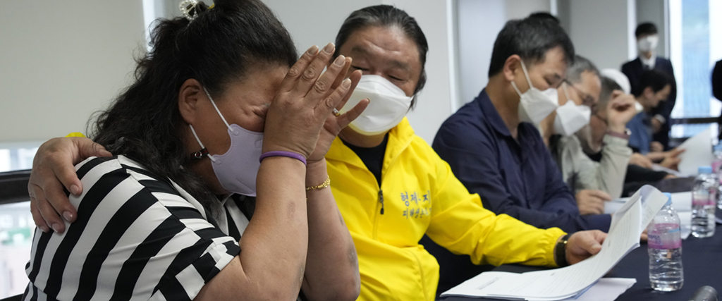 En av överlevarna från interneringslägret i tårar under onsdagens presskonferens.