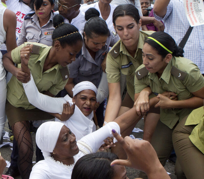Poliskvinnor läpar iväg medlemmar av Ladies in White, en kvinnomotståndsgrupp som kräver frigivning av politiska fångar, under deras veckovisa protest i Havanna, Kuba, söndagen den 20 mars 2016