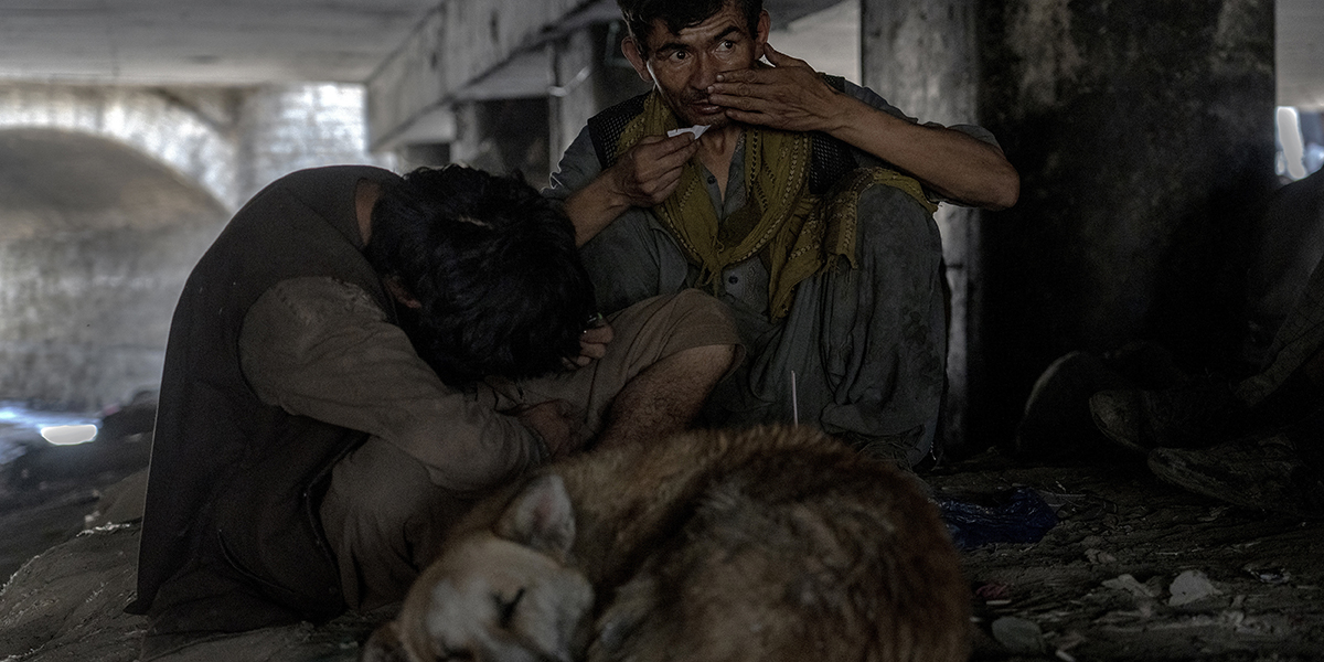 Afghanska missbrukare samlas under en bro för att konsumera droger, mestadels heroin och metamfetamin i Kabul, Afghanistan, juni 2022.