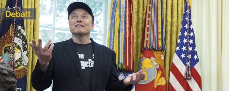 Elon Musk lyfter händerna och ler