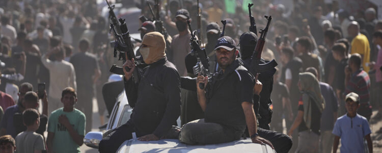 beväpnade soldater på biltak i folksamling