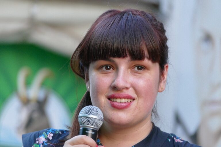 Nika Kovač håller i mikrofon.